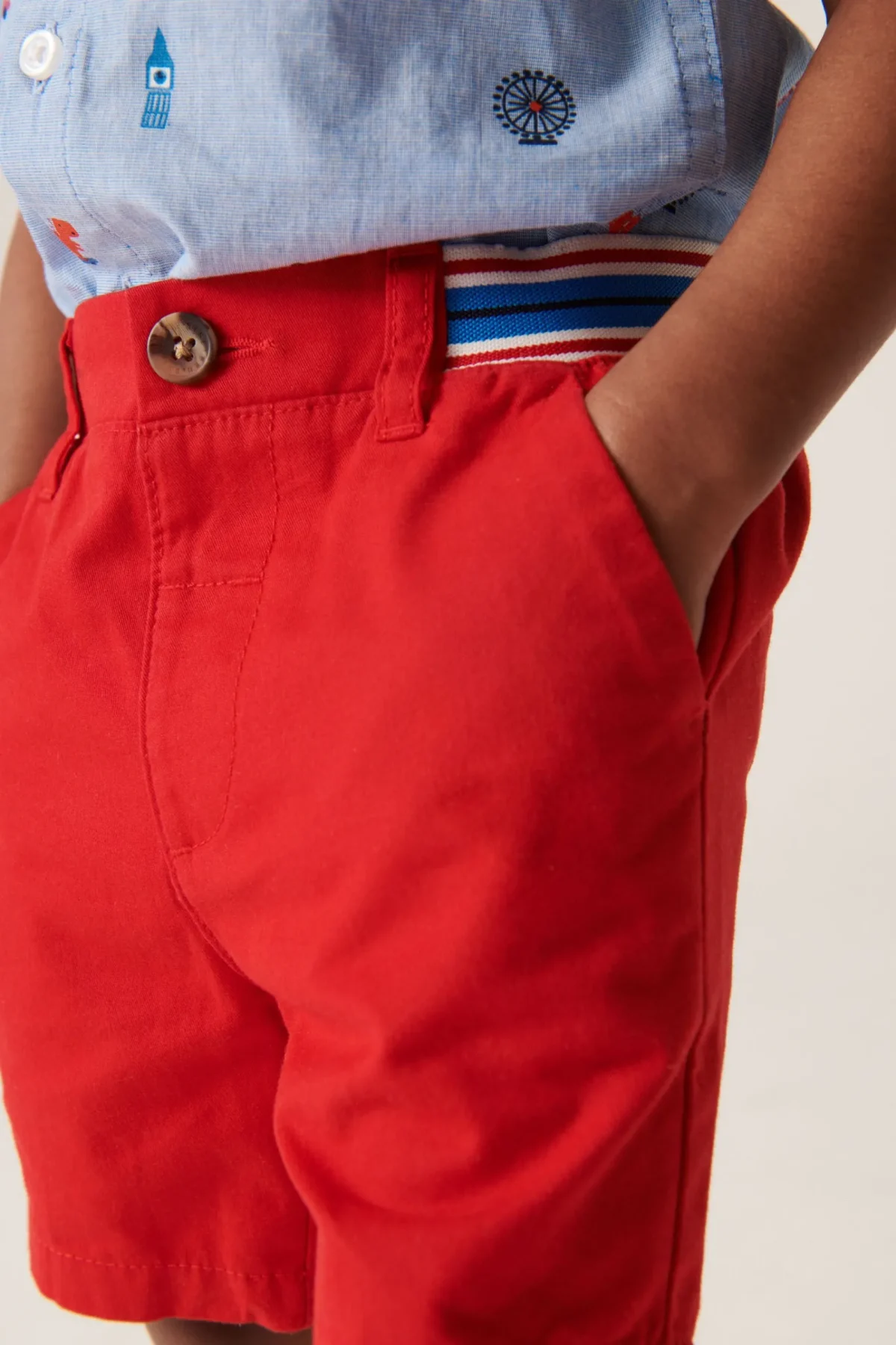official set of red shirt and shorts with dinosaur design
