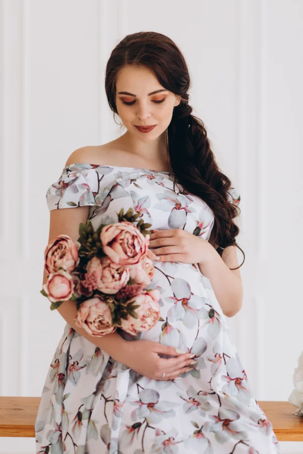 charming young pregnant woman with flowers