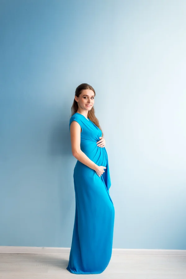 pregnant woman blue dress blue background