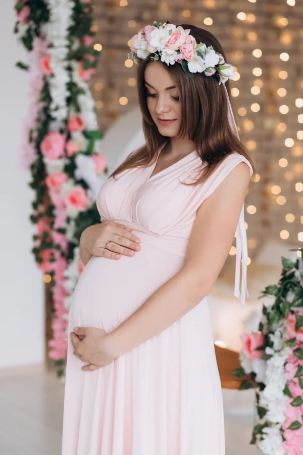 pregnant woman pink dress flower wreath